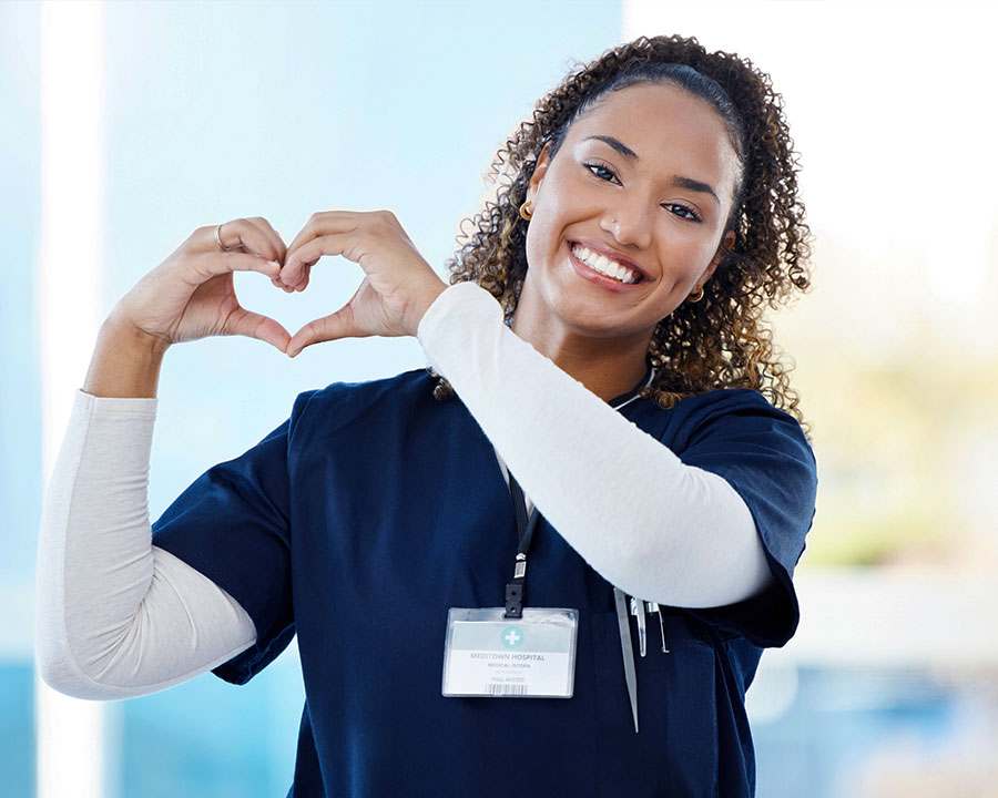 nurse making heart gesture with hands