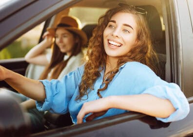happy woman driving in car