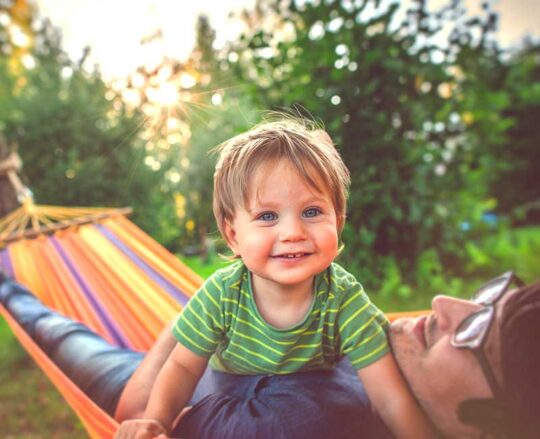 baby and dad in hammock together