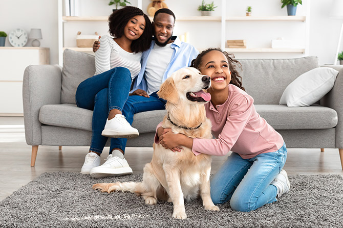 Young family and their dog in living room
