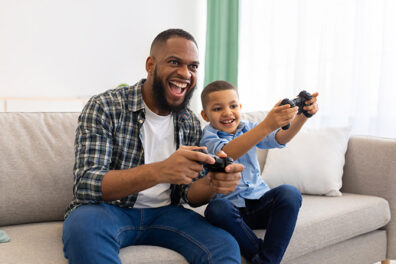 Father and son playing video games together