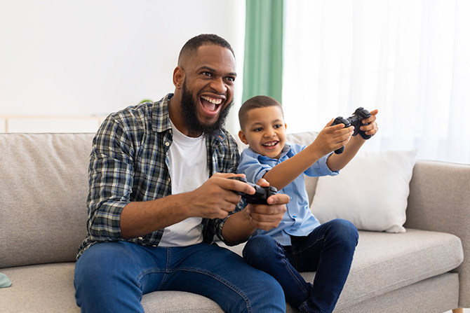 Father and son playing video games together