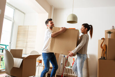 young couple moving with cardboard boxes