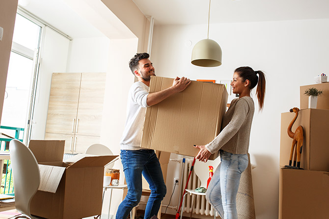 young couple moving with cardboard boxes