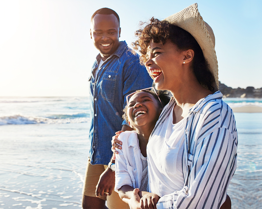 happy family walking along beach