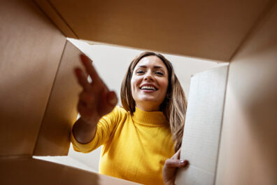 Woman looking inside a cardboard box