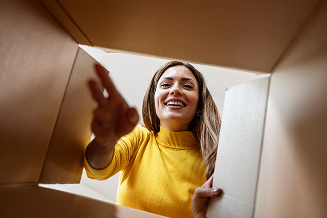 Woman looking inside a cardboard box
