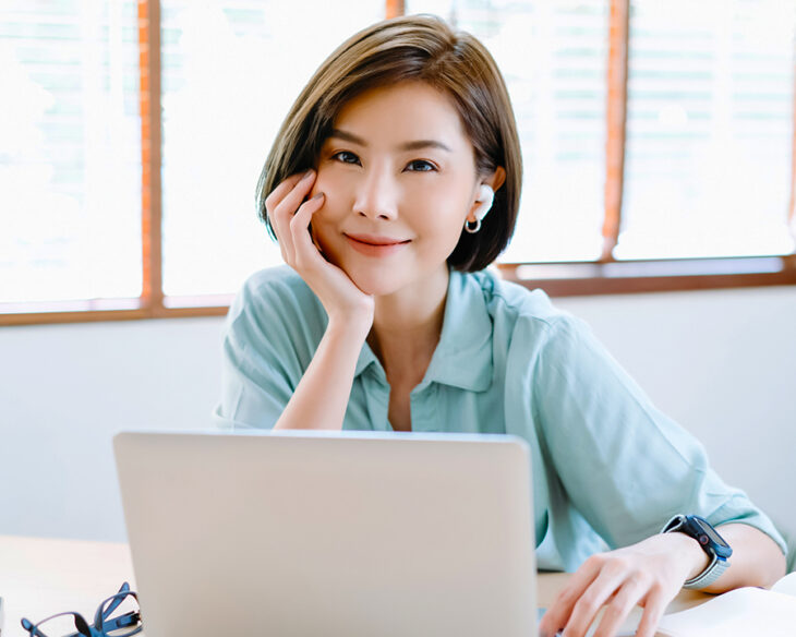 professional woman with laptop smiling