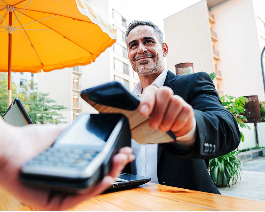 businessman paying with mobile phone
