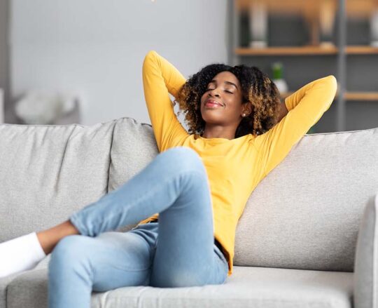 woman sitting on couch relaxing