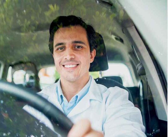 happy doctor driving car