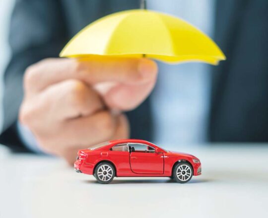 model car underneath yellow umbrella