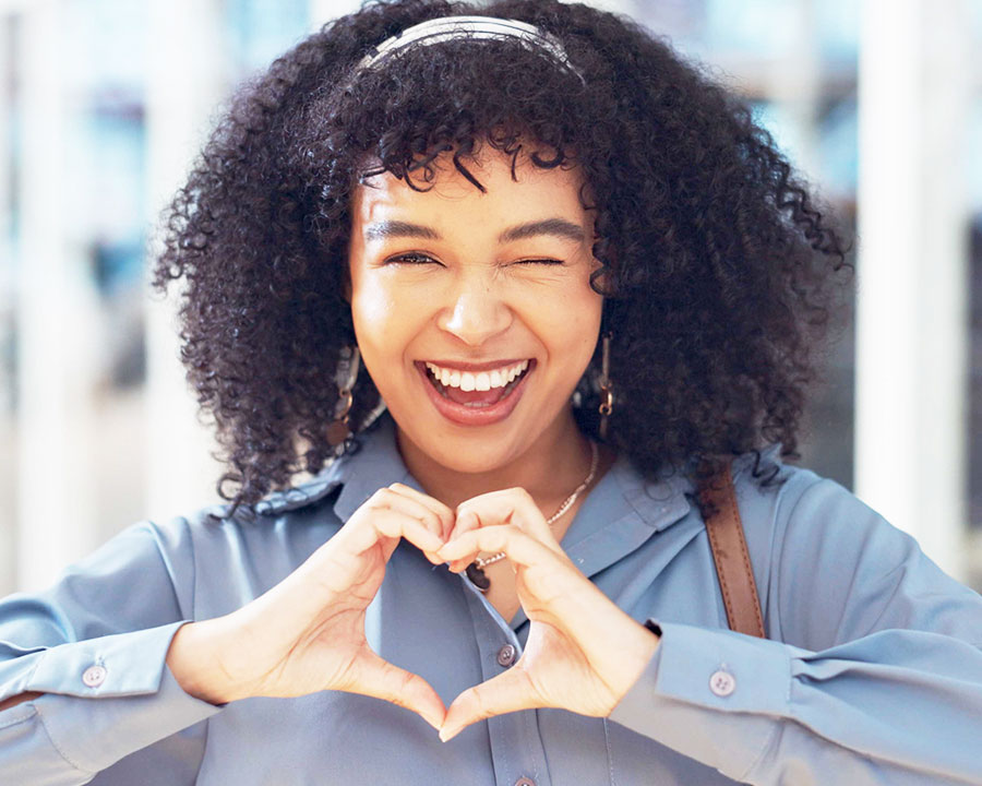 woman making heart gesture with hands