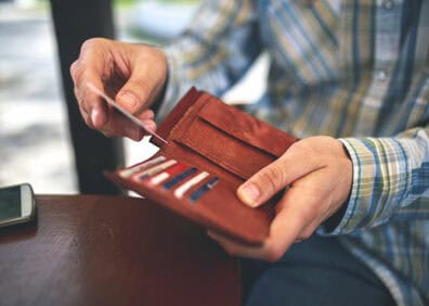 man pulling credit card from wallet