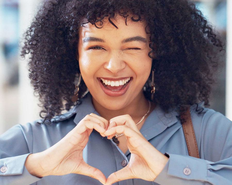 woman making heart gesture with hands