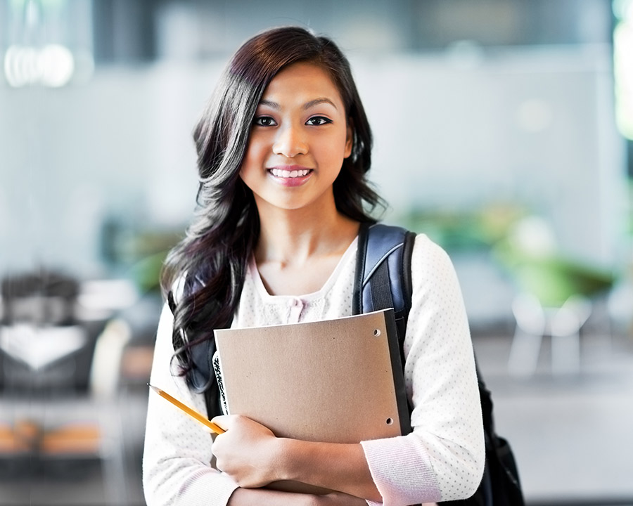 happy female student holding books